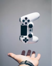 gaming controller upright above a hand